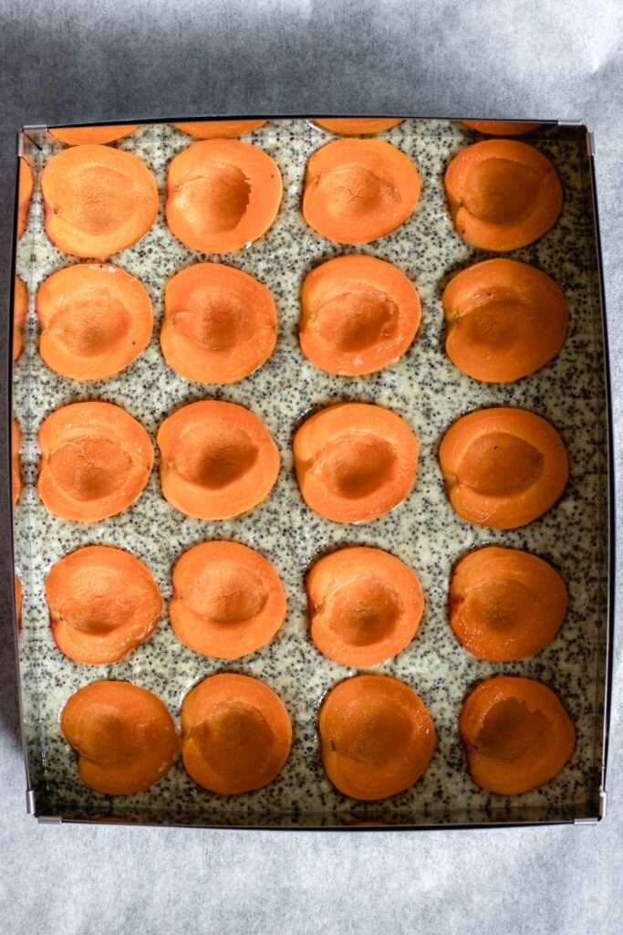 unbaked cake topped with apricots