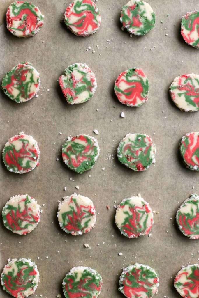 die gekühlte rolle in ca. 4 mm dicke scheiben schneien und auf einem backblech verteilen. backen.